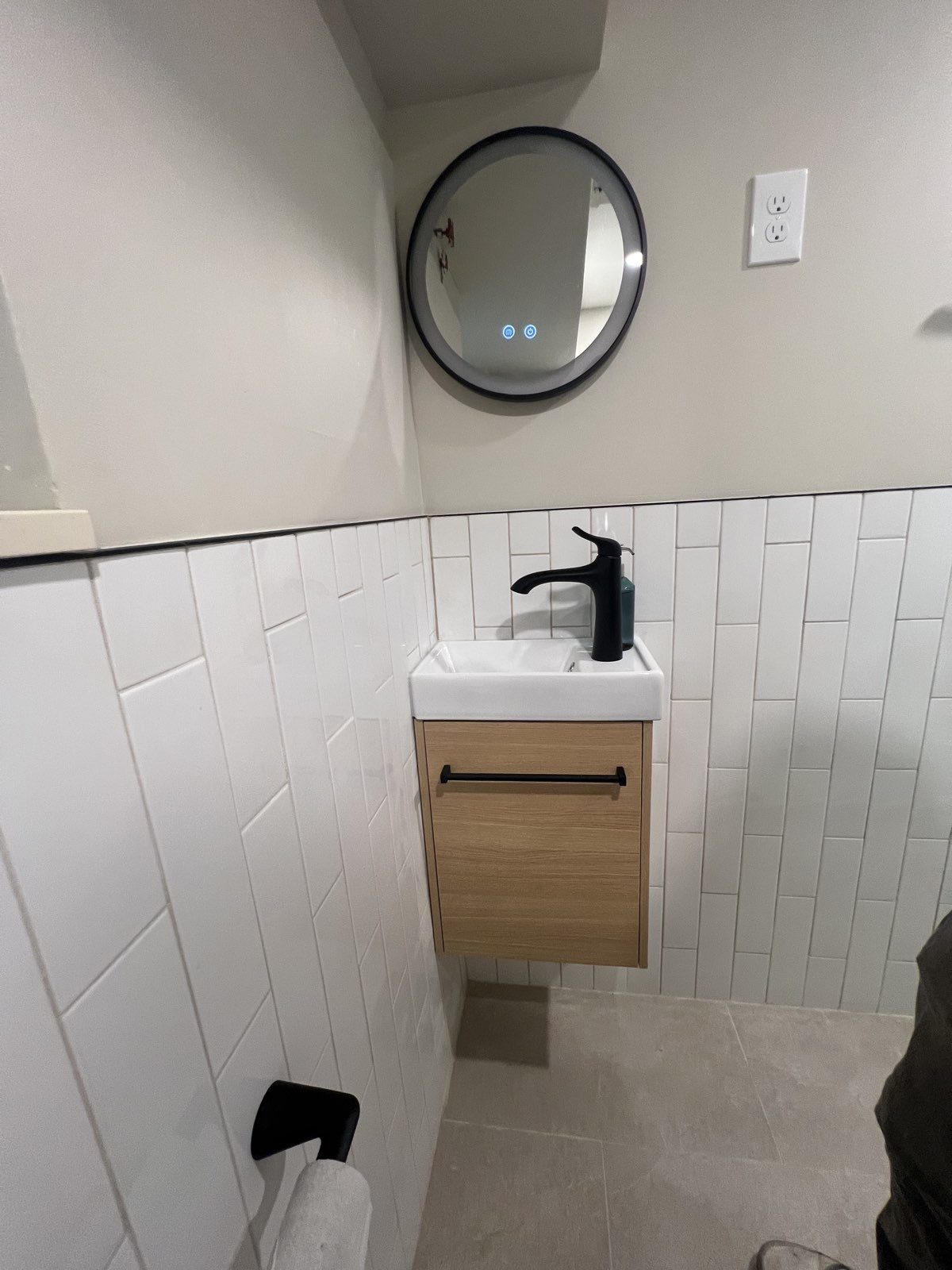 Remodeled bathroom with floating oak vanity and stacked tile