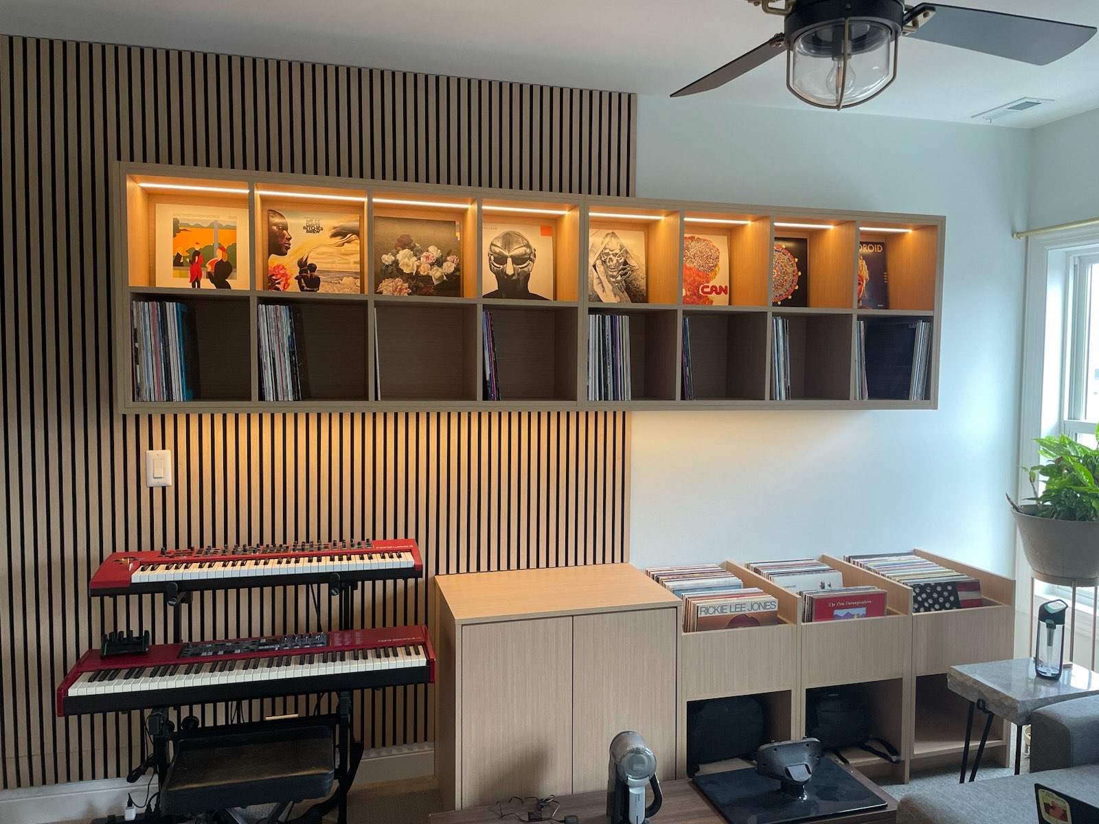 Custom built-in record storage with lit display niches and slat wall