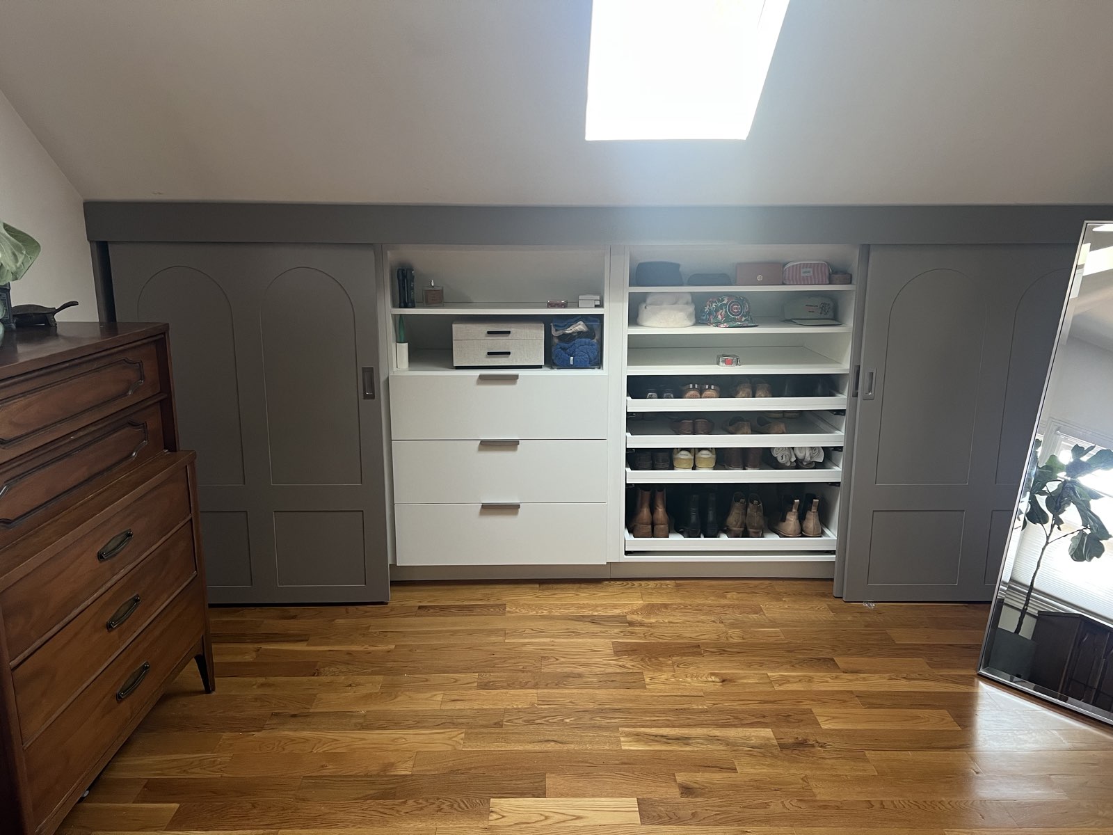 Custom attic closet with sliding doors and pull-out shoe shelving