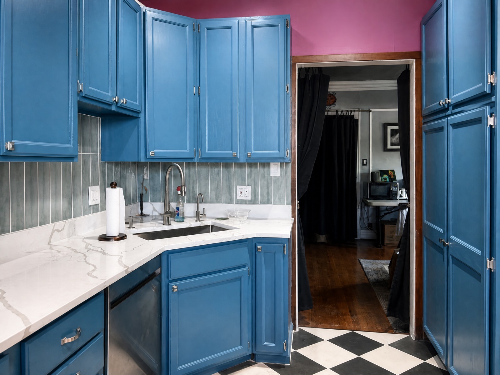 Remodeled kitchen with blue cabinetry and quartz counters